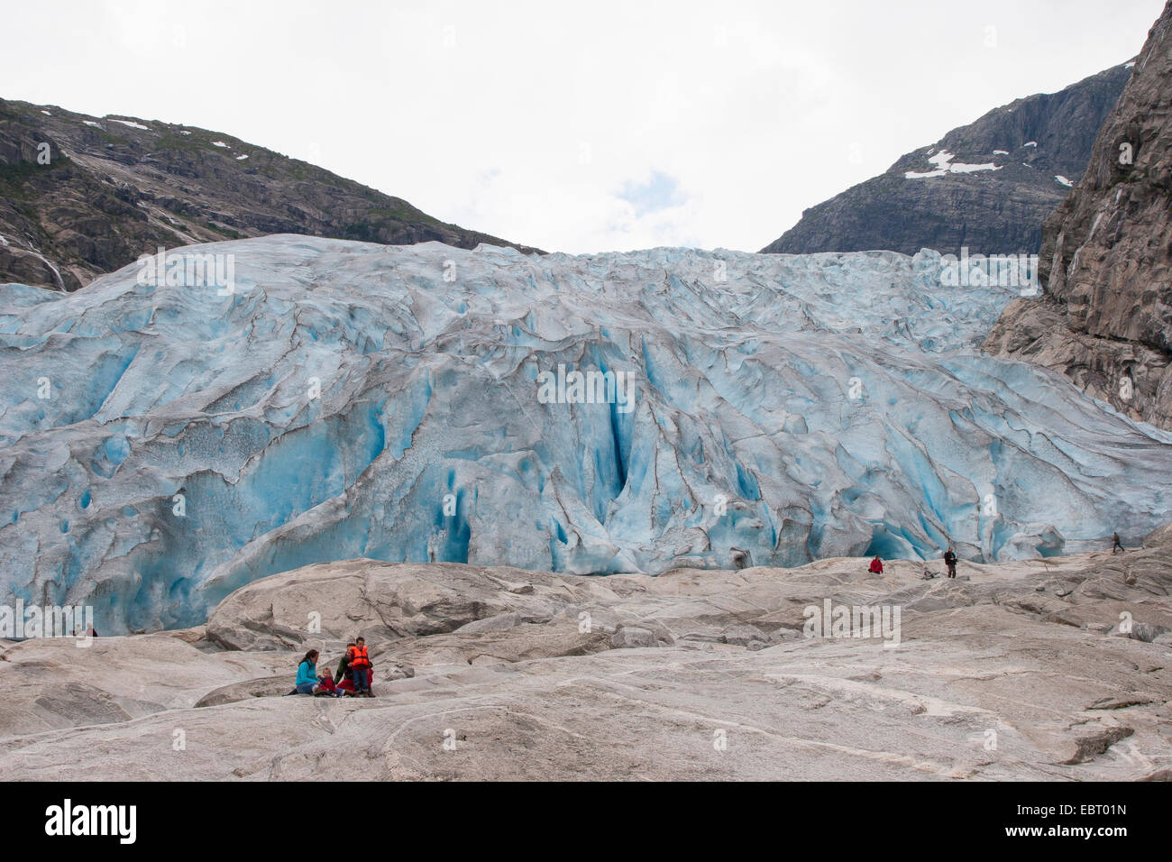 tourists in front of Nigardsbreen glacier tongue , Norway, Jostedalsbreen National Park Stock Photo