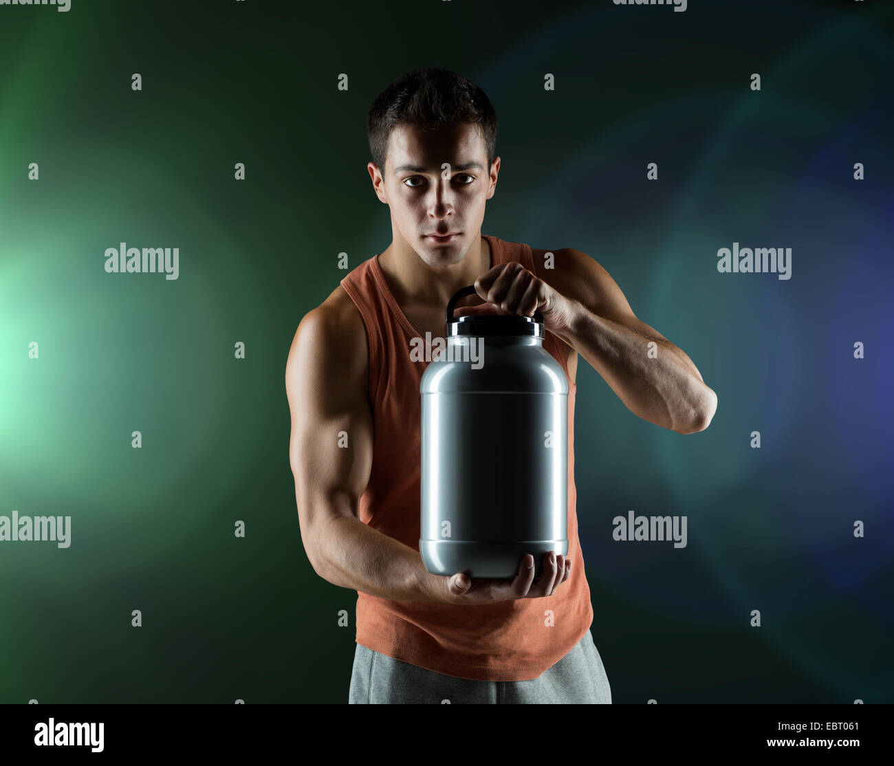 young male bodybuilder holding jar with protein Stock Photo - Alamy