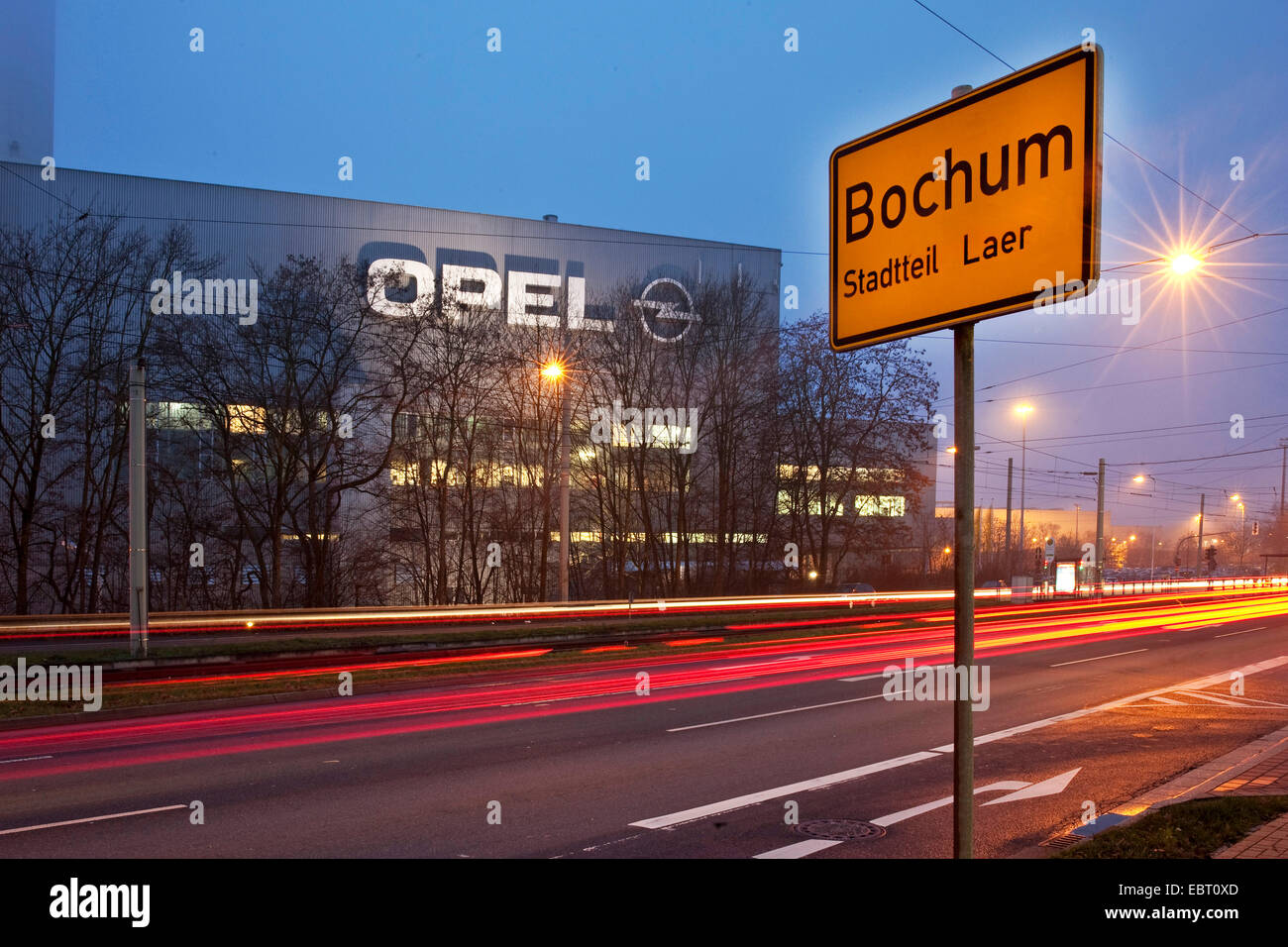Opel factory and place name sign on Bochum in evening light, Germany, North Rhine-Westphalia, Ruhr Area, Bochum Stock Photo