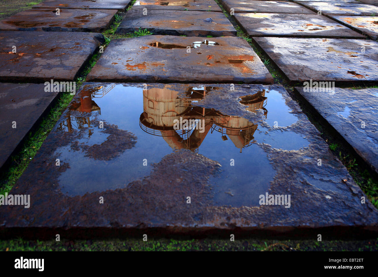 former steel mill in Landschaftspark Duisburg-Nord mirroring in a puddle, Germany, North Rhine-Westphalia, Ruhr Area, Duisburg Stock Photo