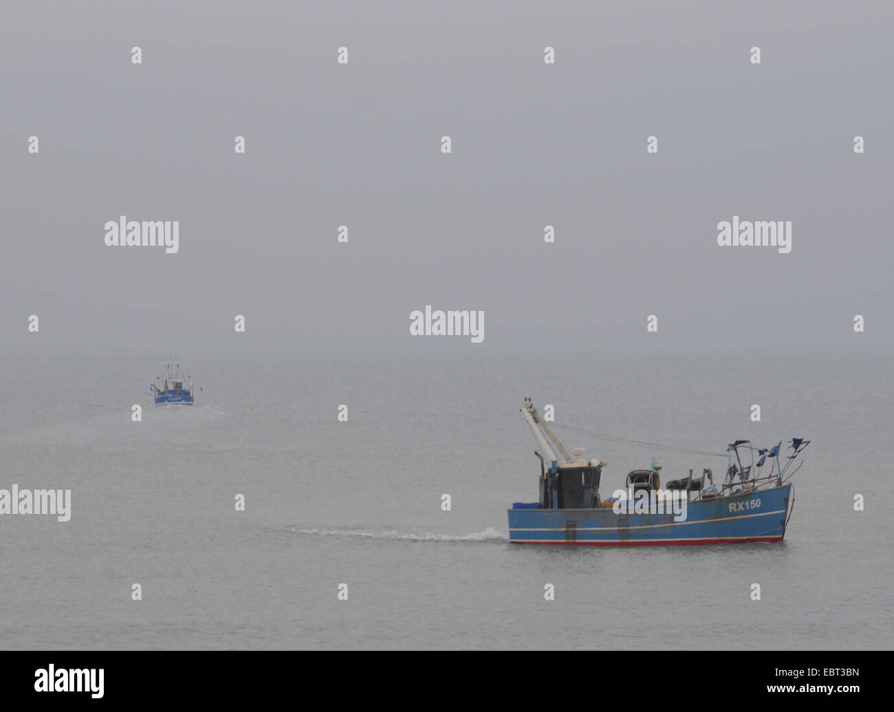 Hastings, East Sussex, UK. 4th December 2014. A cold misty overcast afternoon with temperature approaching freezing as Fishing boats set to sea on the South Coast Stock Photo