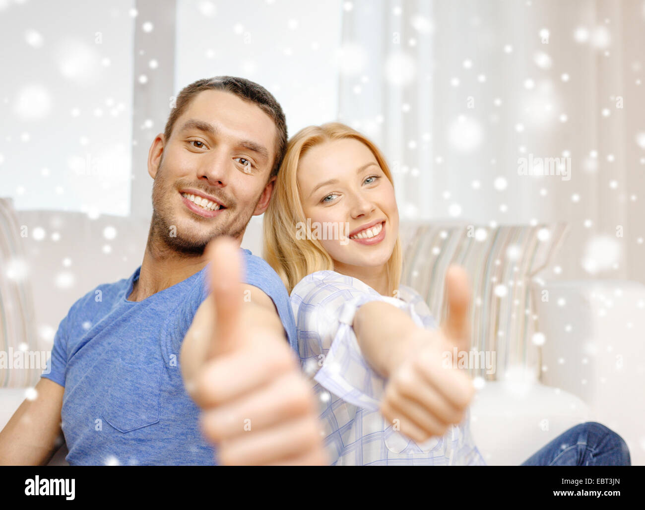 happy couple showing thumbs up and hugging Stock Photo