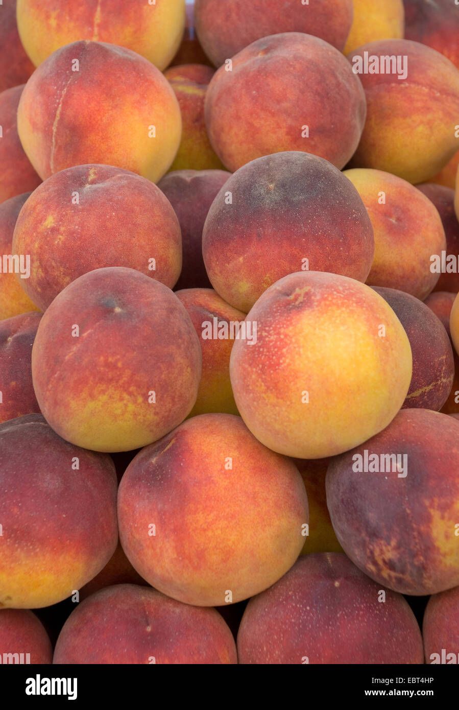 Juicy and ripe fresh peaches on display and ready for purchase Stock Photo
