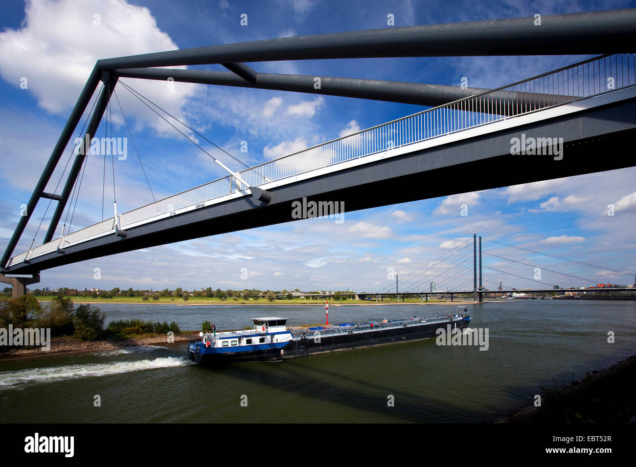 a ship on Rhine crossing pedestrian bridge, Rheinkniebruecke in background, Germany, North Rhine-Westphalia, Duesseldorf Stock Photo
