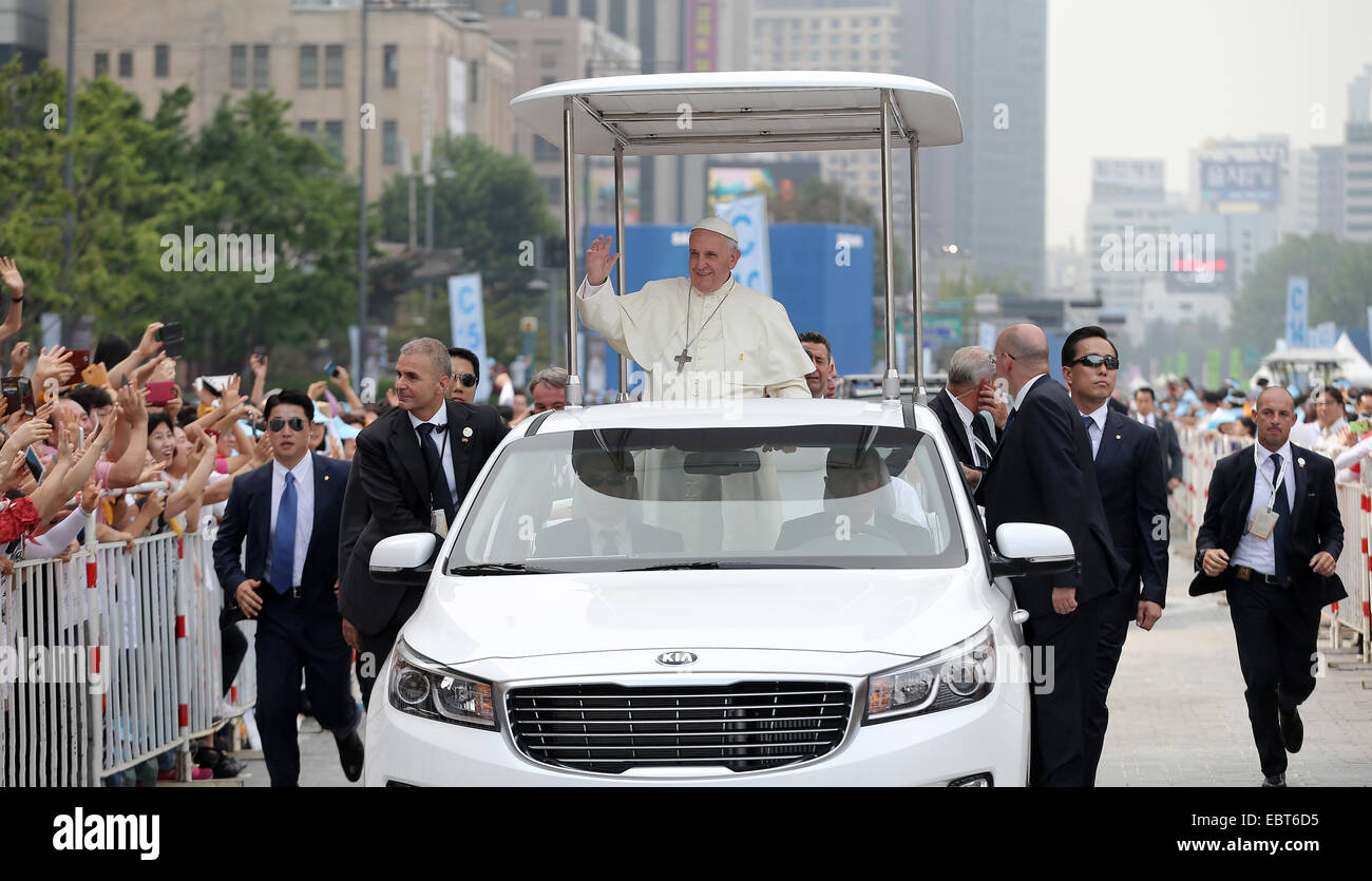 Pope Francis enters the Haemi Fortress in a white open-topped car, to celebrate the closing Mass of the sixth Asian Youth Day August 17, 2014 in Seosan, South Korea. The Pontiff is in South Korea on the first papal visit to the Asian nation in a quarter century. Stock Photo