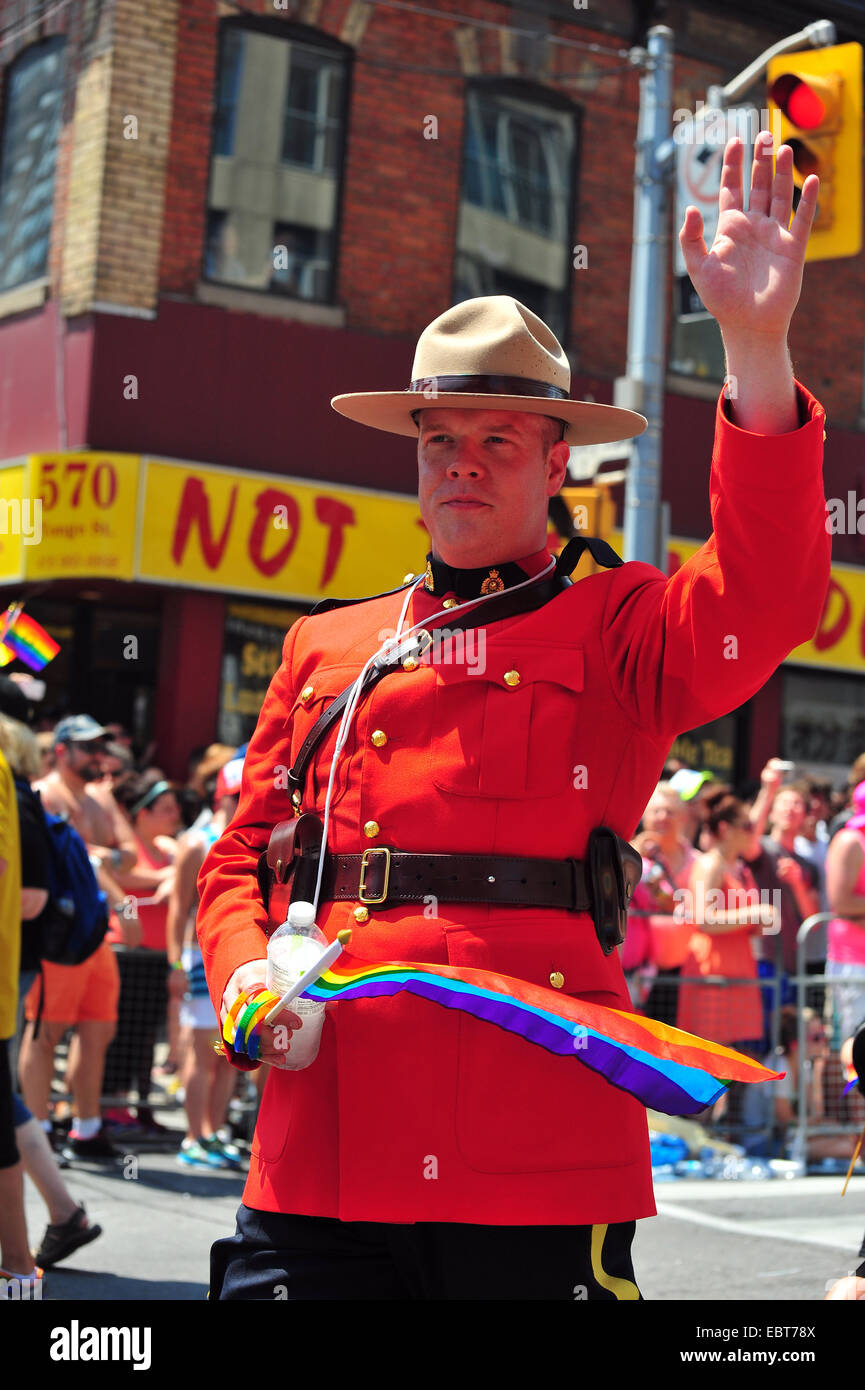 A Canadian Mounty waves at the 2014 World Pride in Toronto. Stock Photo