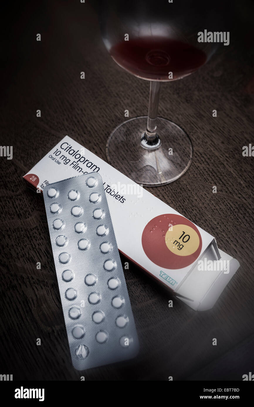 Antidepressant tablets and a glass of red wine. Stock Photo