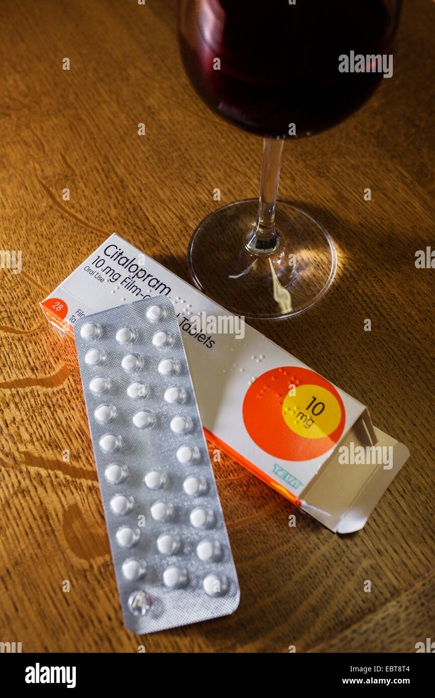 Antidepressant tablets and a glass of red wine. Stock Photo