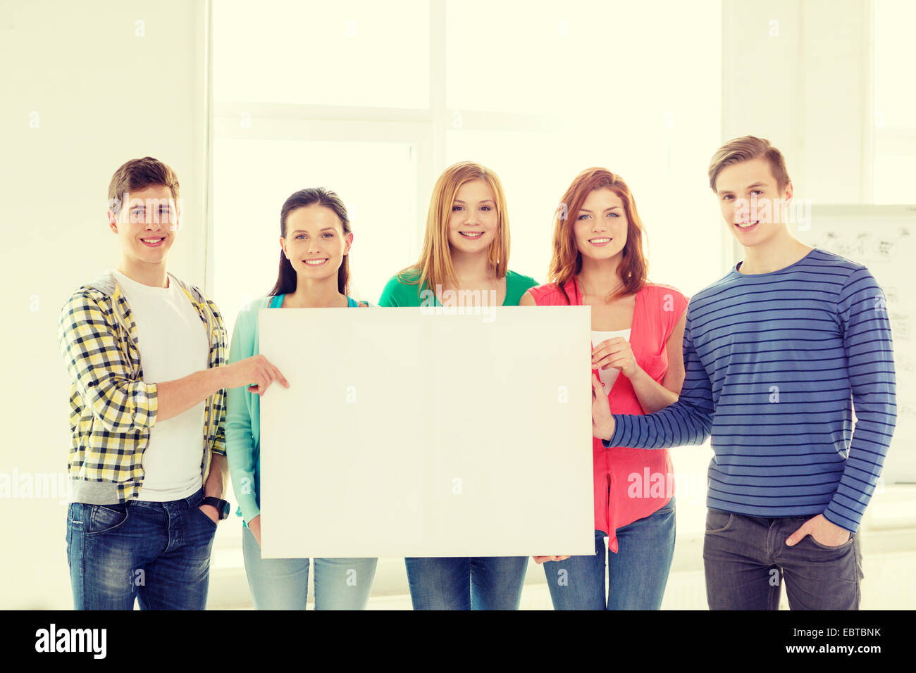 students at school holding white blank board Stock Photo