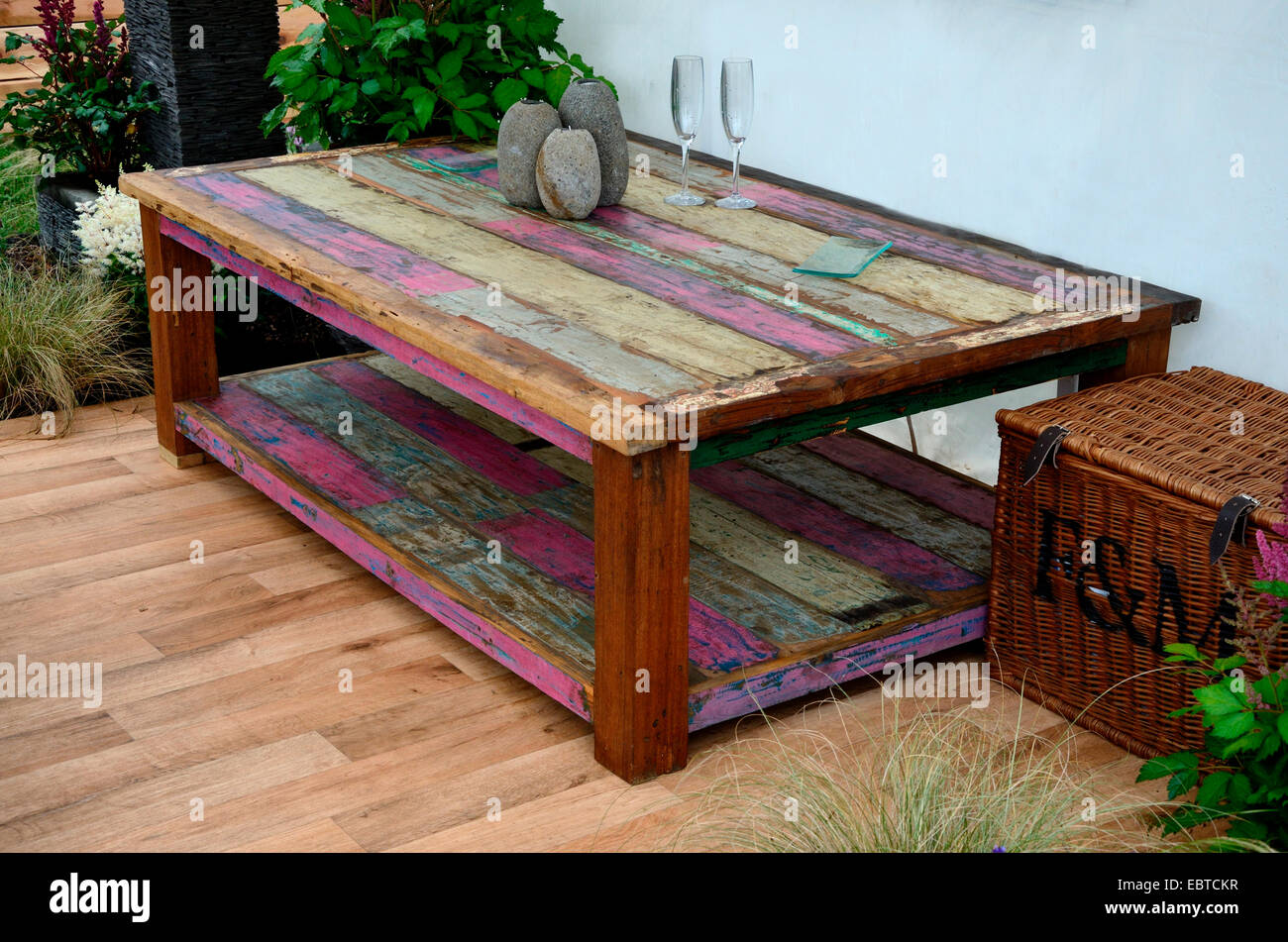 A large coffee table stained and made from reclaimed timber with accessories Stock Photo