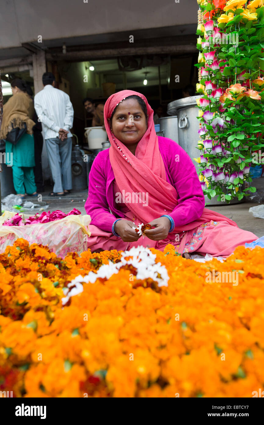 Woman selling flowers around Paharganj, the Main Bazaar in New Delhi, India Stock Photo