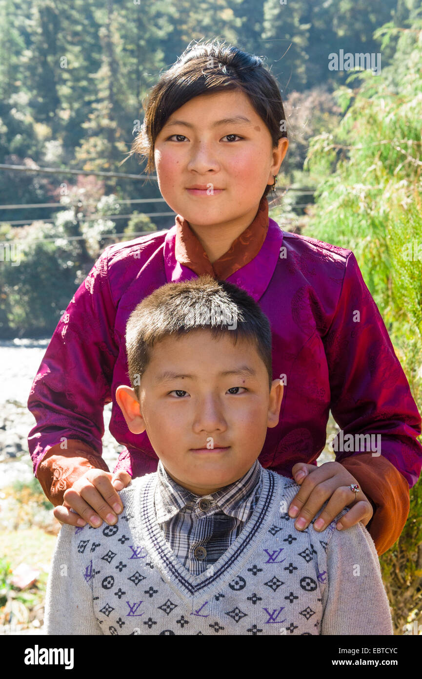 Portrait of beautiful girl and her little brother in Chendebji stupa, Bhutan Stock Photo