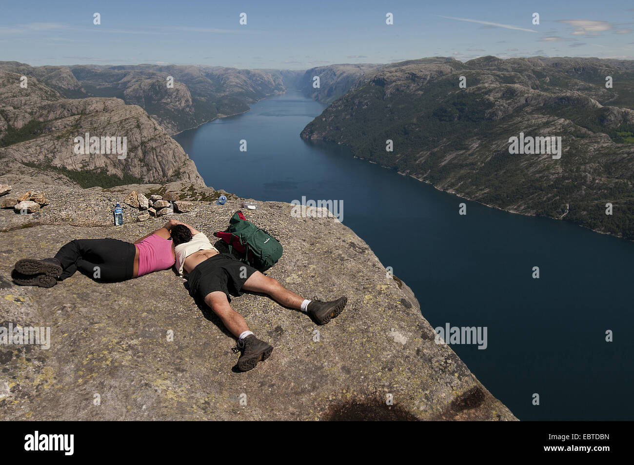 panoramic view over the Lysefjord  from the rock plateau 'Preikestolen' with resting tourists, Norway, Rogaland Stock Photo