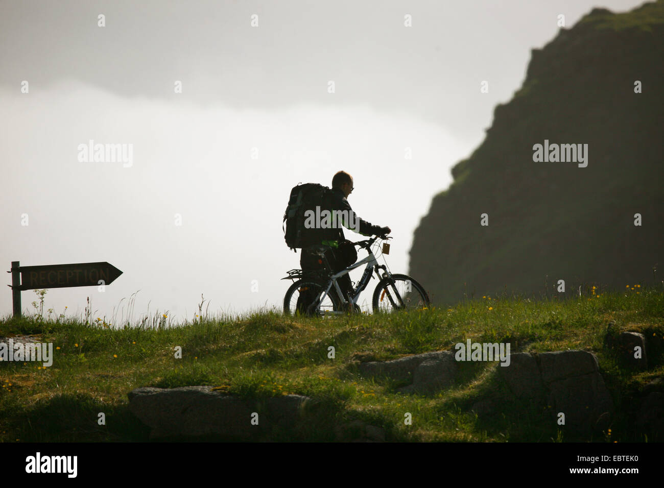 backpacker wheeling his bicycle, Norway, Lofoten Islands Stock Photo