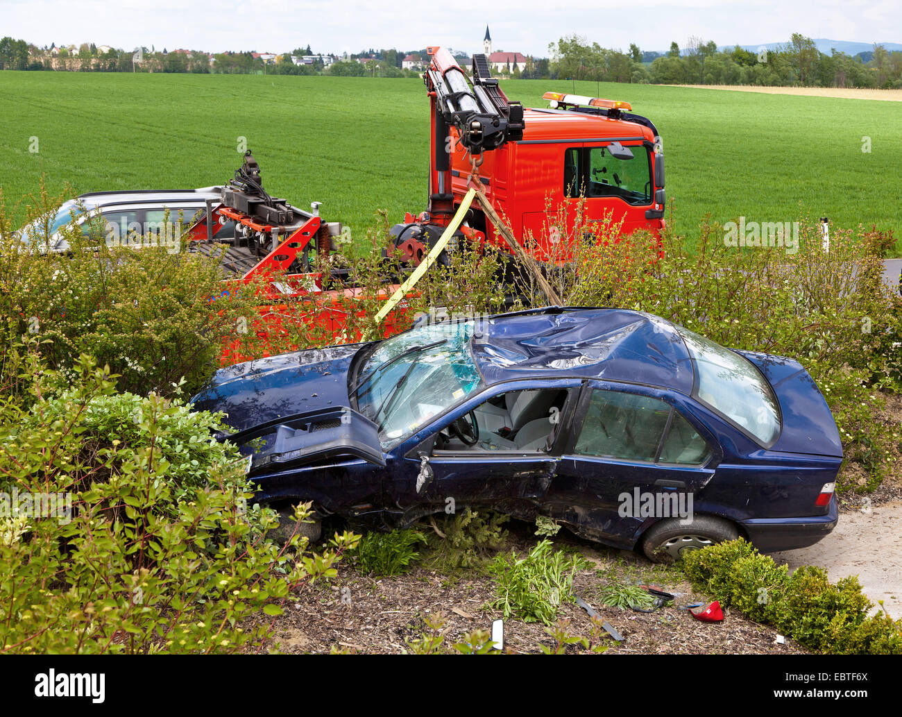 wrecked car being retrieved from a roadside after a traffic accident Stock Photo
