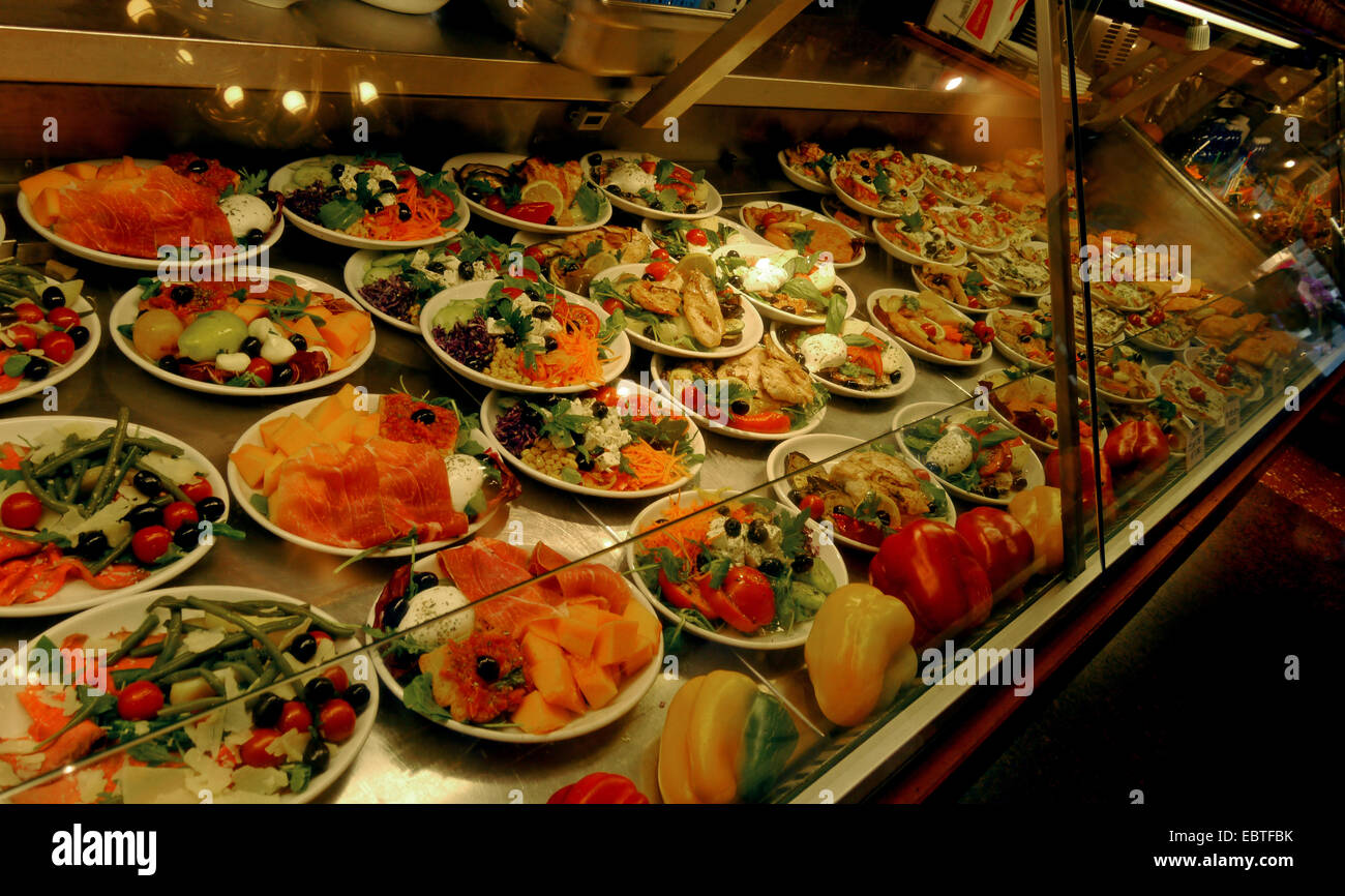 A chiller cabinet in an Italian restaurant with plates of colorful food. Stock Photo