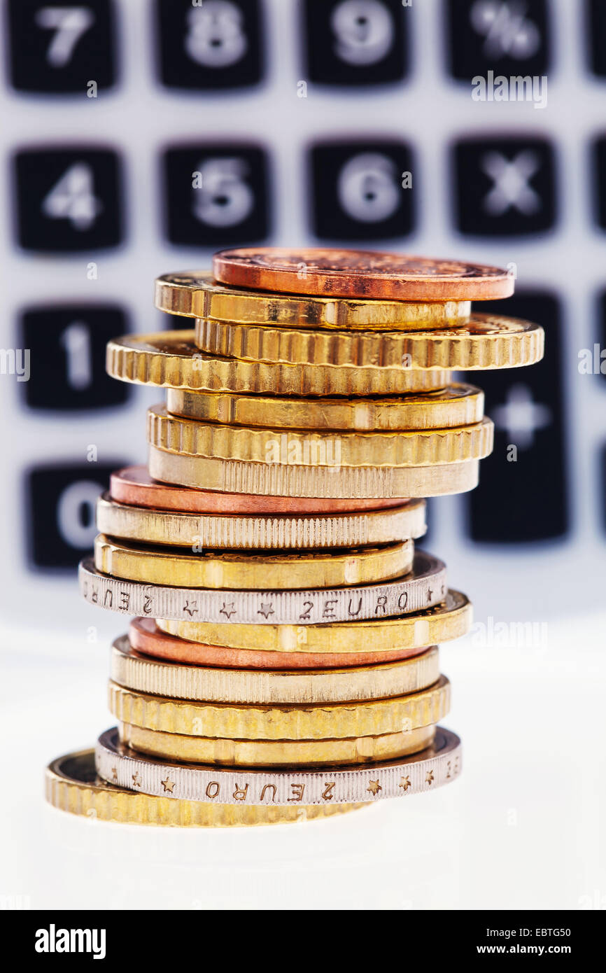 stack of coins of euro cents with desk-top calculators Stock Photo