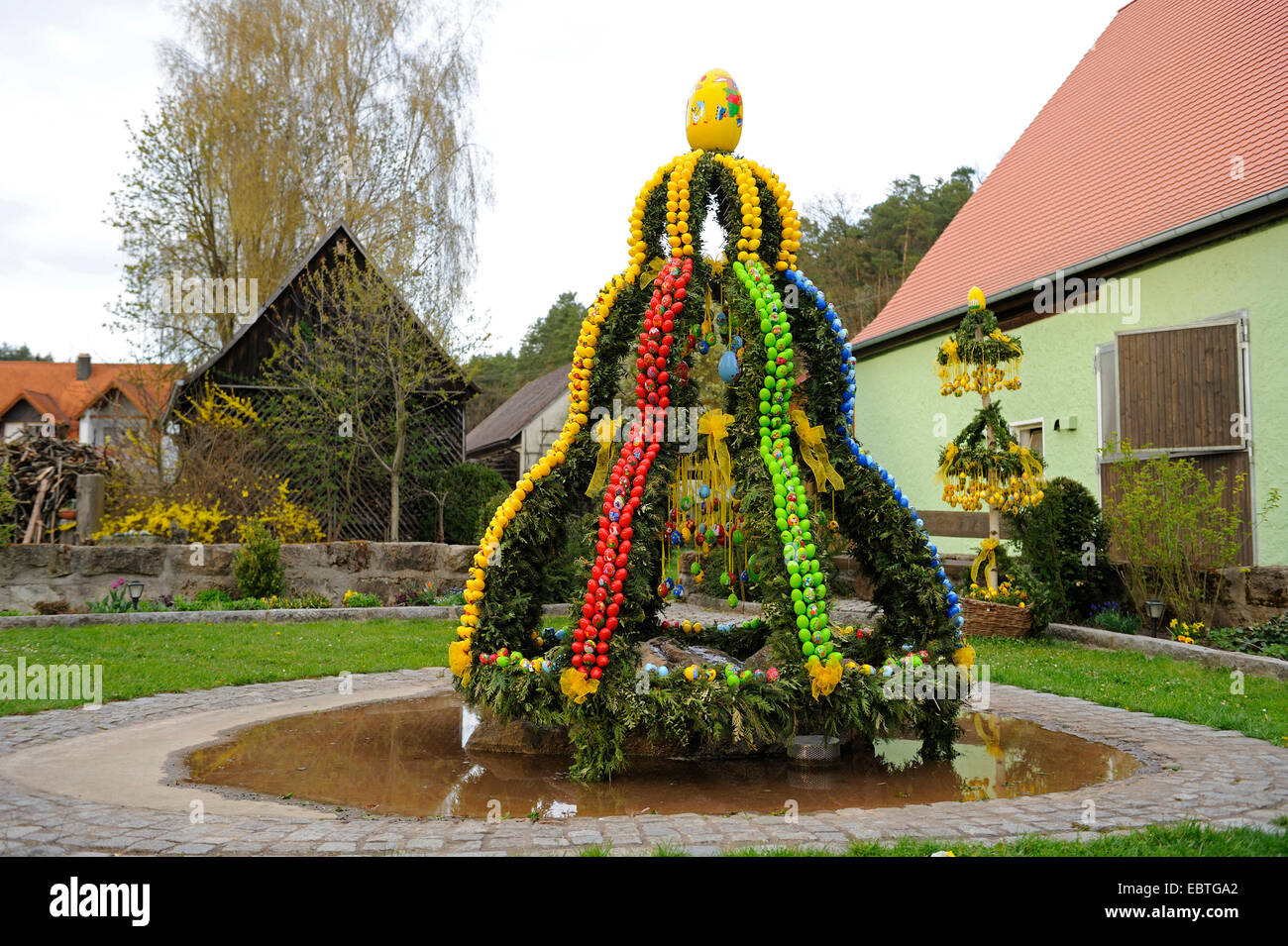 flower arrangement in a park in the shape of a bell decorated with Easter eggs, Germany, Bavaria, Franken, Franconia Stock Photo