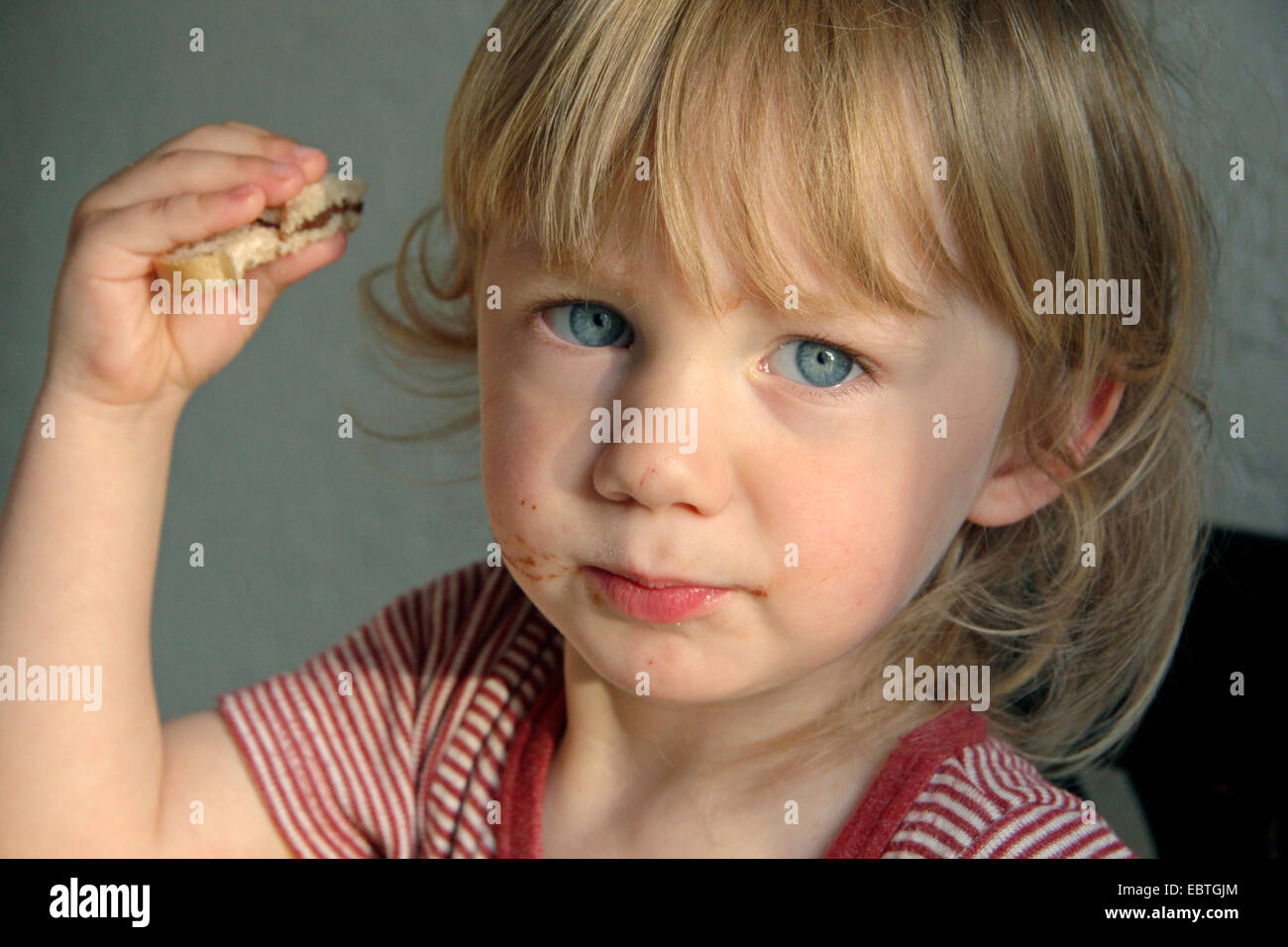little boy eating a sandwich, Germany Stock Photo