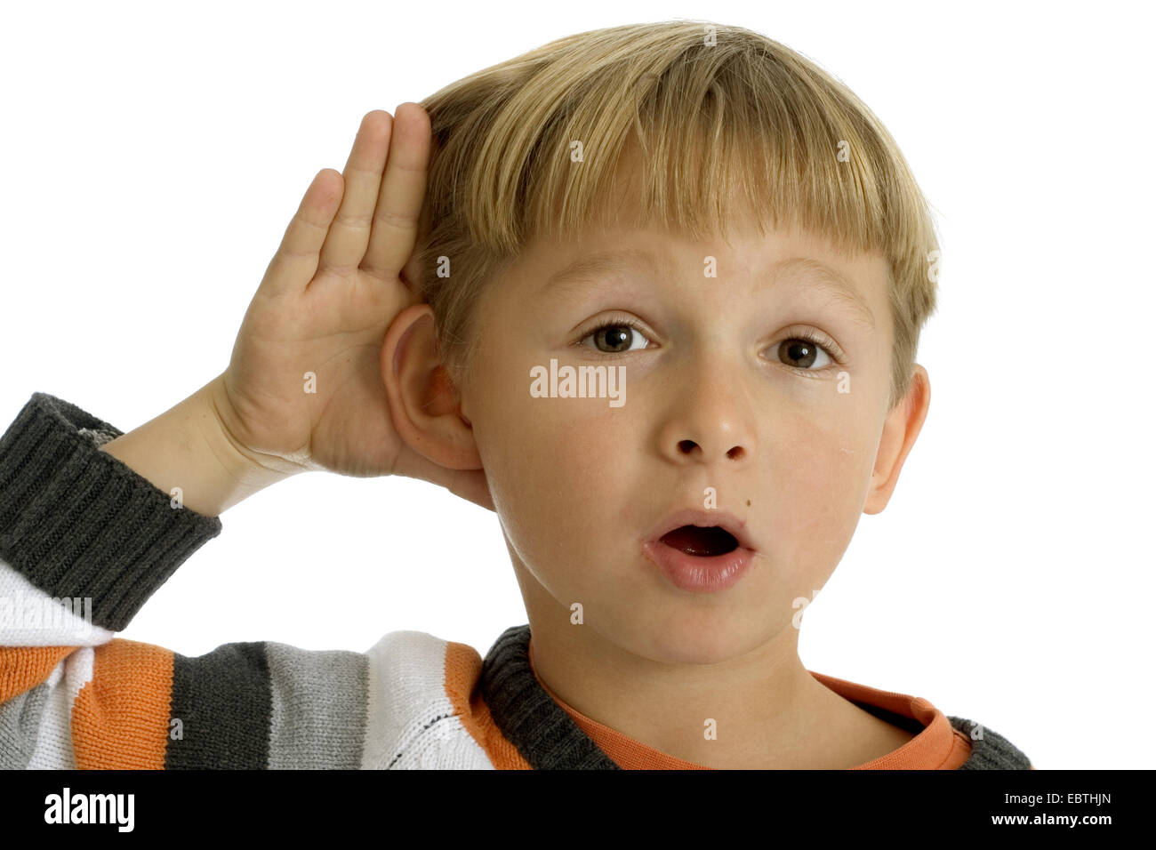 little boy holding a hand to the ear Stock Photo