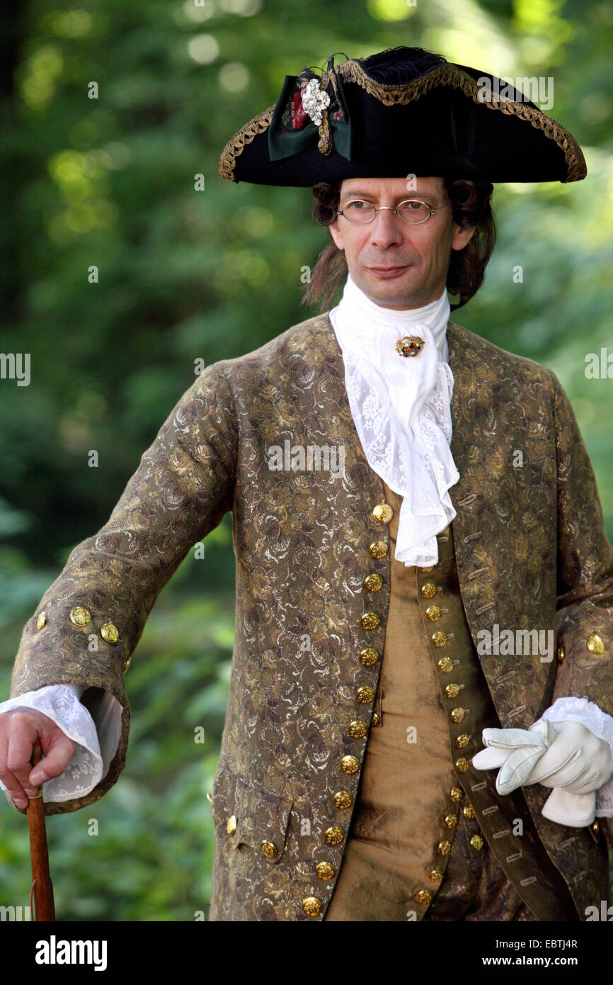 aristocrat standing in the garden in baroque clothing Stock Photo