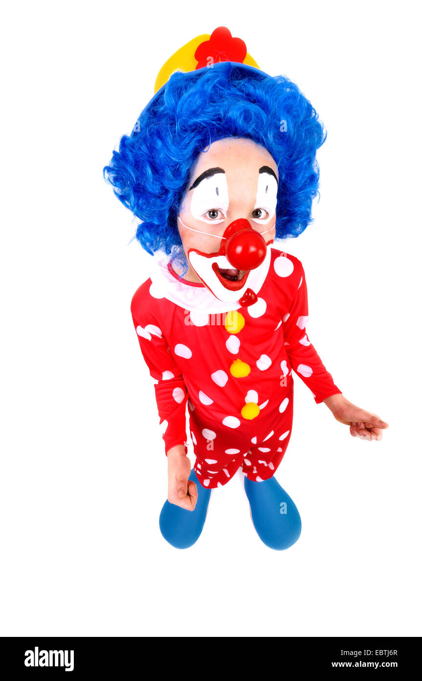 little clown with yellow hat, blue wig and false red nose thumping up Stock Photo