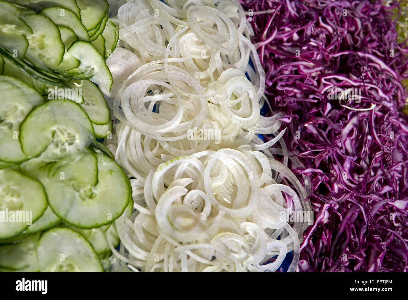 uncooked vegetarian food, cucumbers, onions, red cabbage Stock Photo