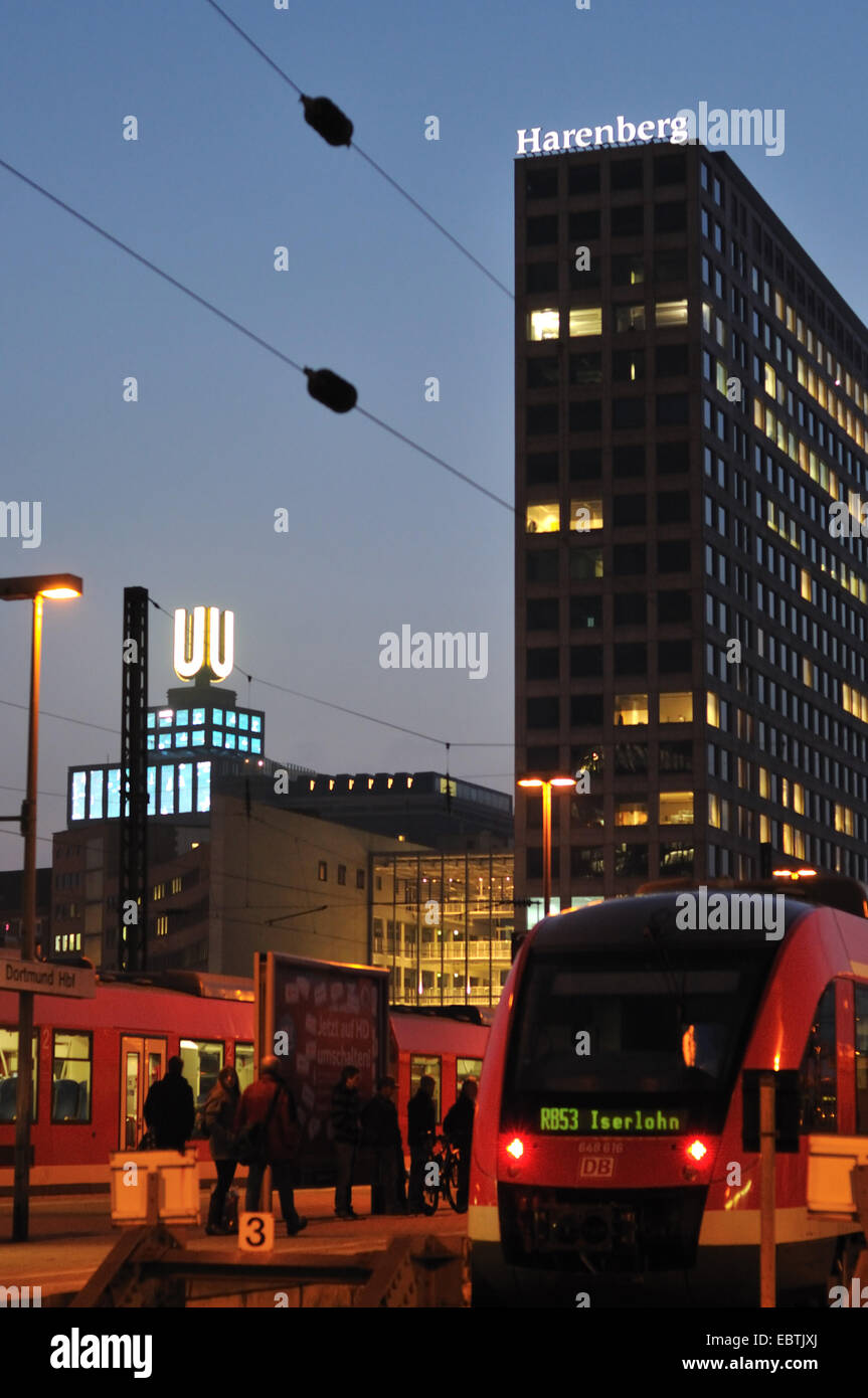 regional trains in front of Harenberg City-Center and Dortmund U-Tower in twilight, Germany, Ruhr Area, Dortmund Stock Photo