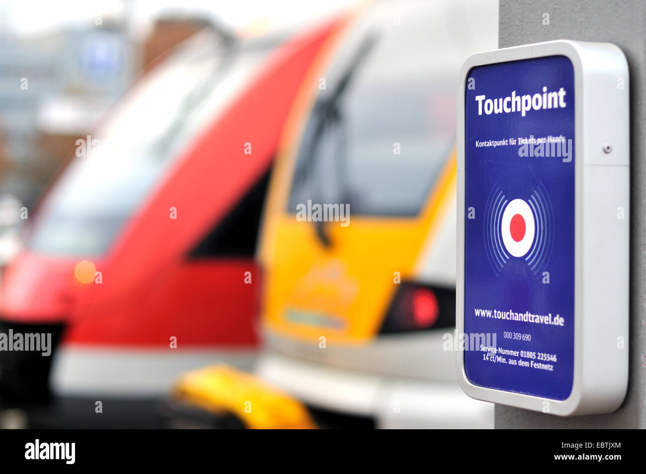 touchpoint at train plattform, two trains in background, Germany Stock Photo