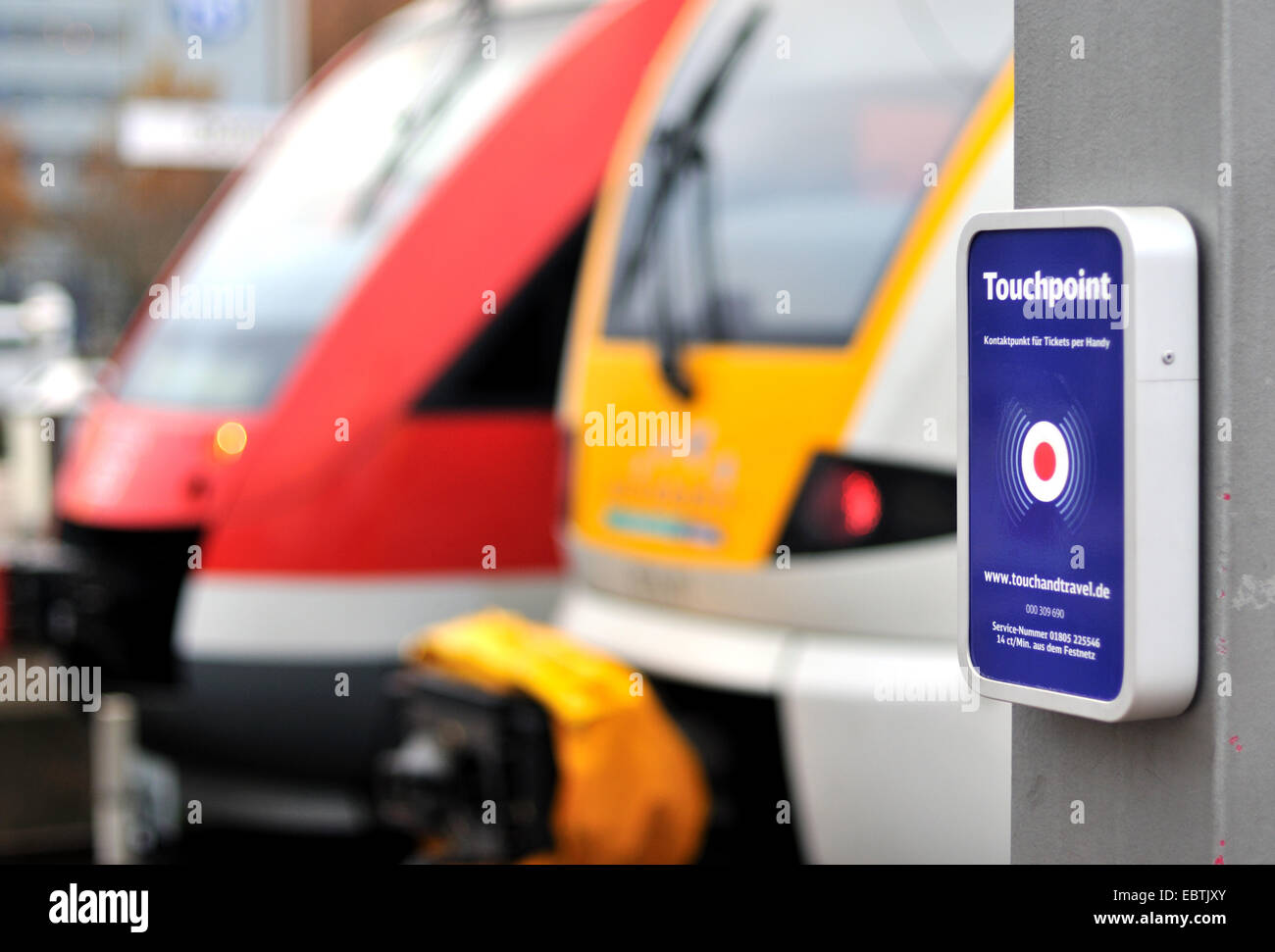 touchpoint at train plattform, two trains in background, Germany Stock Photo