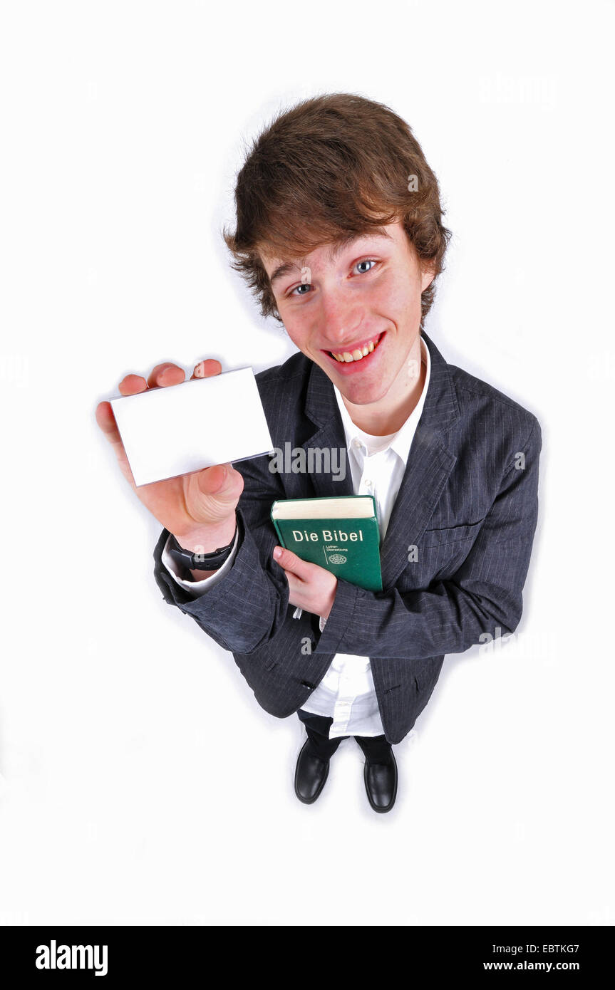teenager with bible showing an empty card Stock Photo