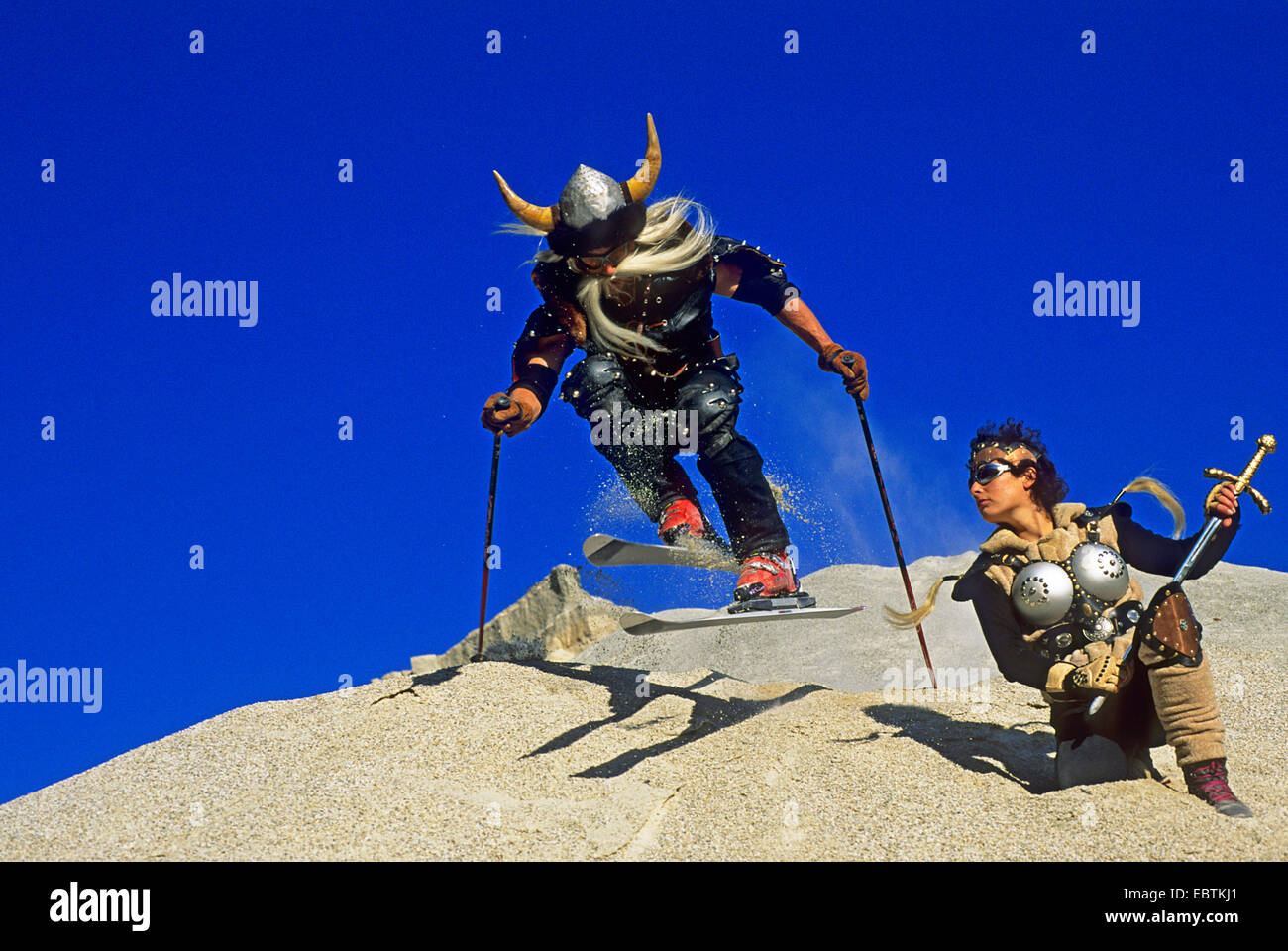 freeride skier disguised as viking going downhill on gravel slope Stock