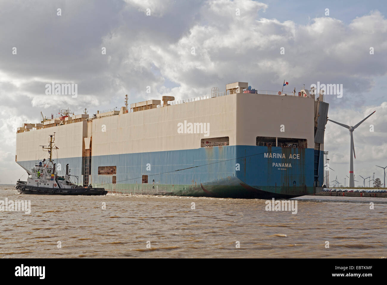 car carrier Marina Ace and harbour tug Radbod, Germany, Lower Saxony Stock Photo