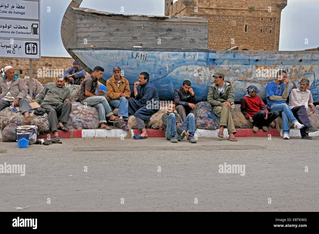 day men waiting for work in harbour, Morocco, Essaouira Stock Photo - Alamy