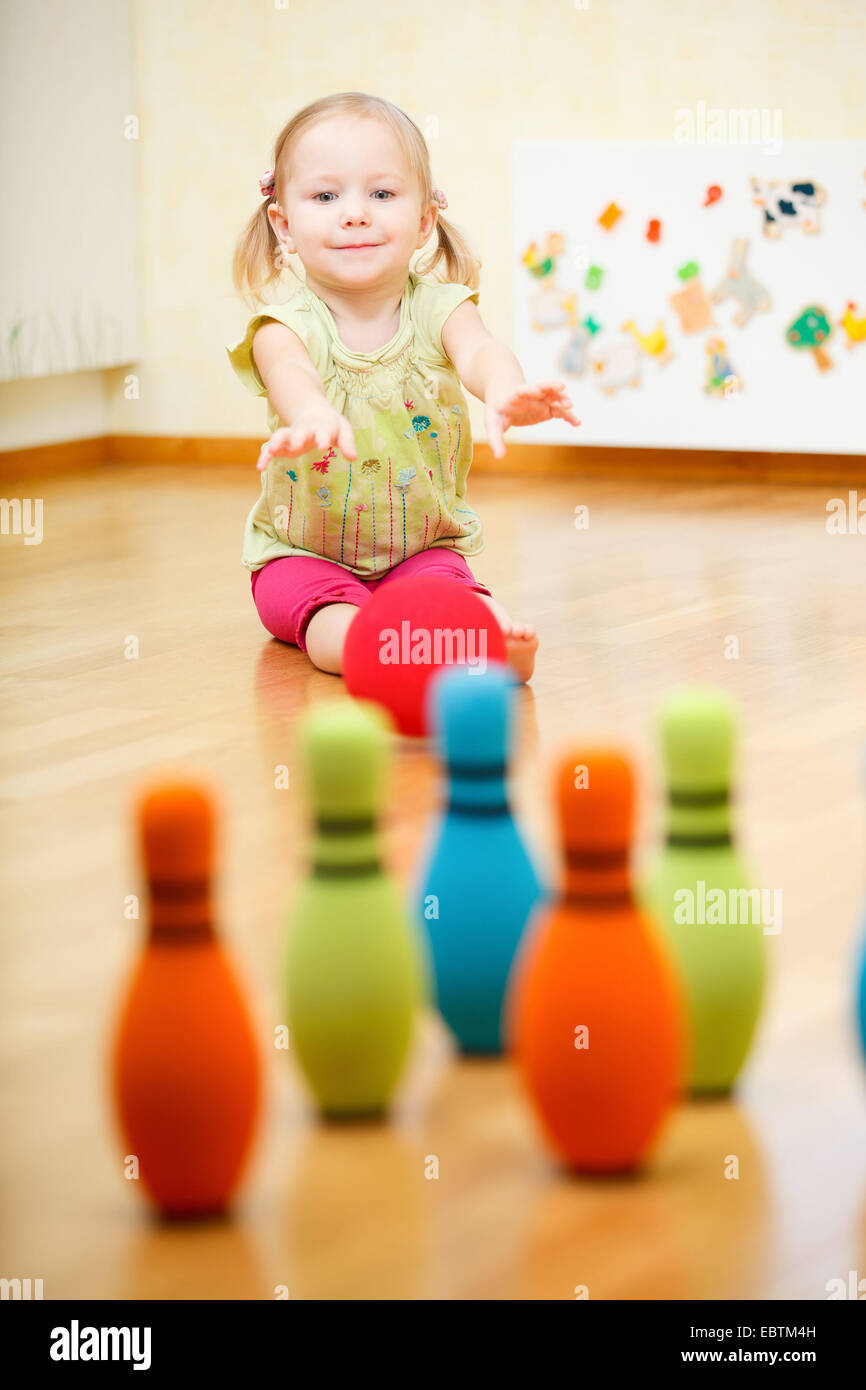 little girl bowling in the nursery Stock Photo Alamy