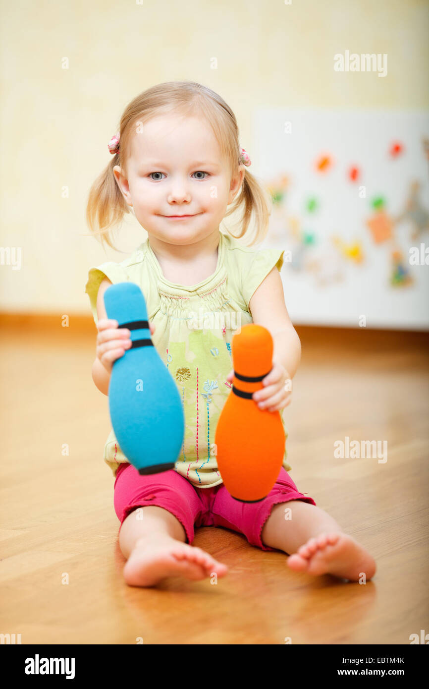 little girl bowling in the nursery Stock Photo Alamy