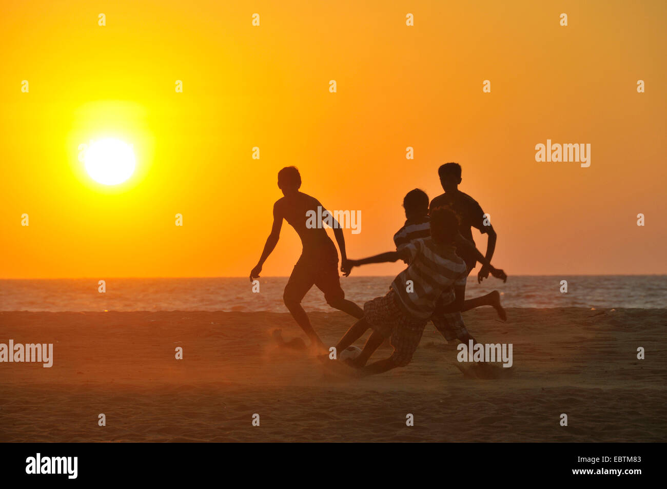 children playing football on the beach, Sri Lanka, Negombo Stock Photo