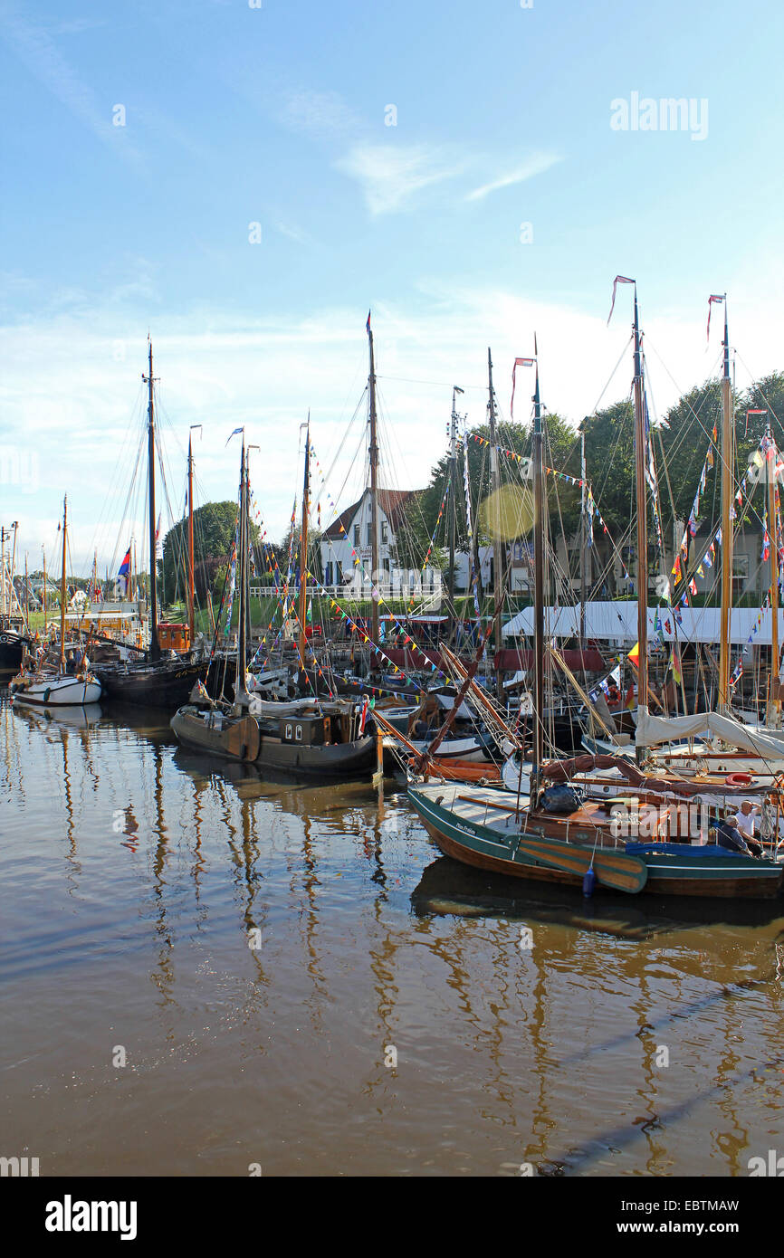 ships in the harbour adorned with colourful flags and pennants for thr harbour festival, Germany, Lower Saxony, East Frisia, Carolinensiel Stock Photo