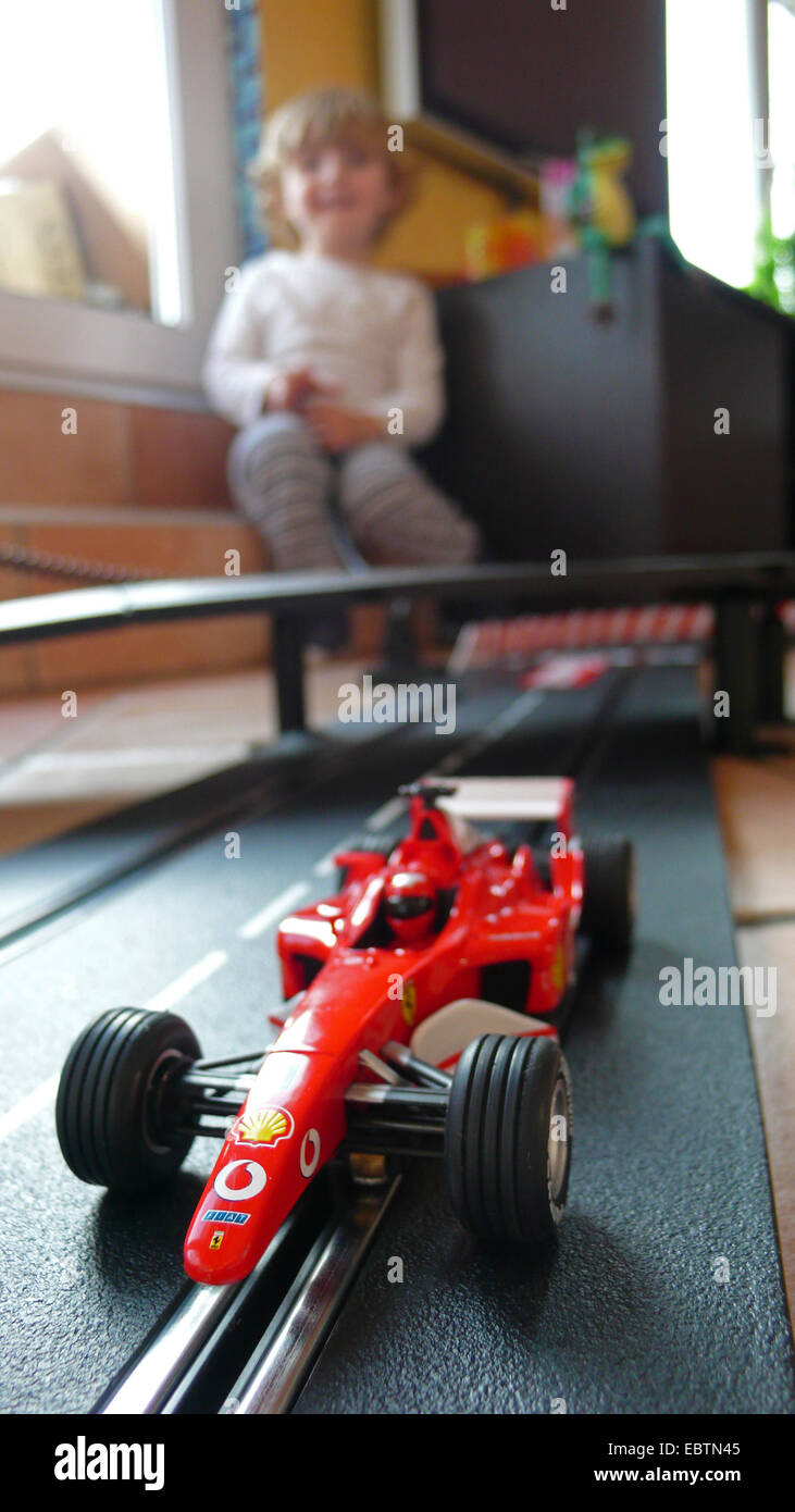 boy playing with a slot car racing track Stock Photo