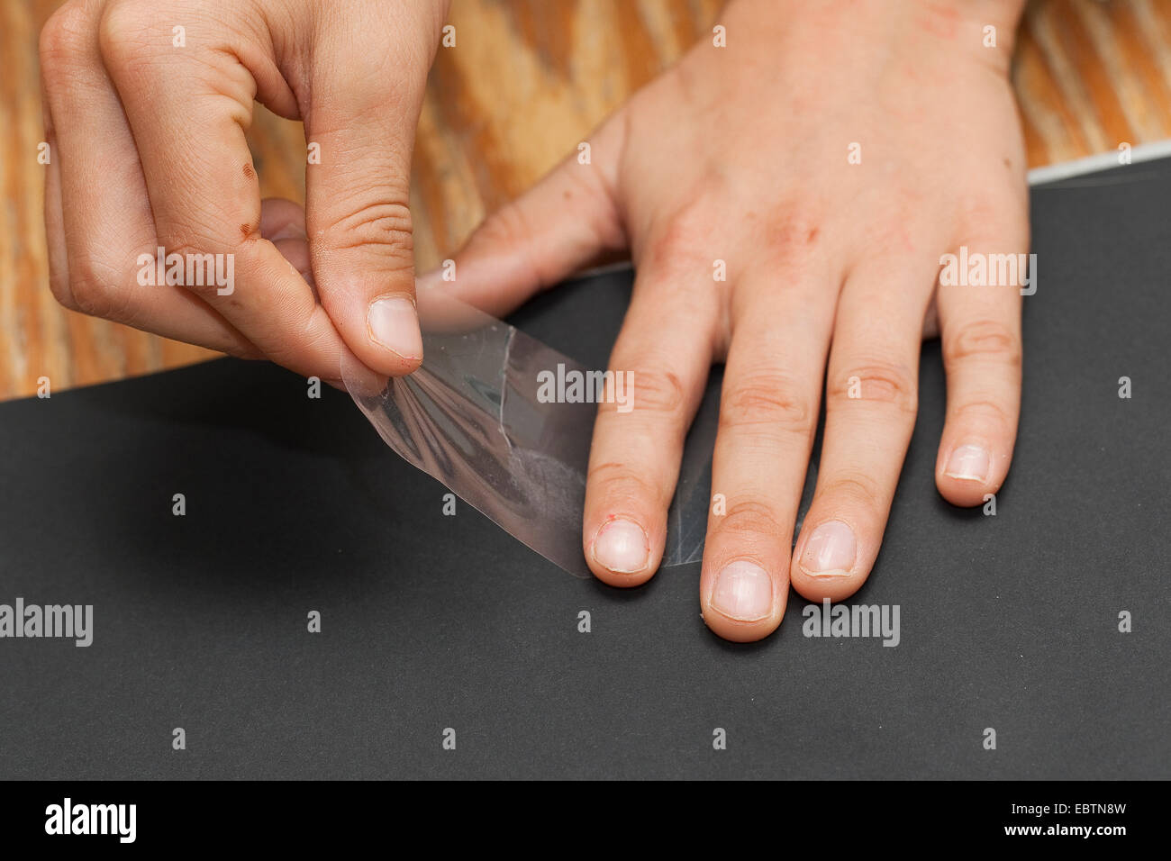 taking fingerprints. Step 5: the fingerprint fixed on a transparent cellotape is sticked on a black board Stock Photo