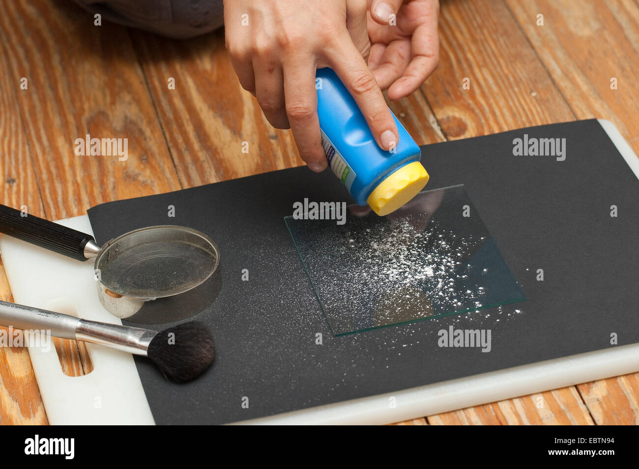 taking fingerprints. Step 2: powder is scattered on a glass panel with a finger-print Stock Photo