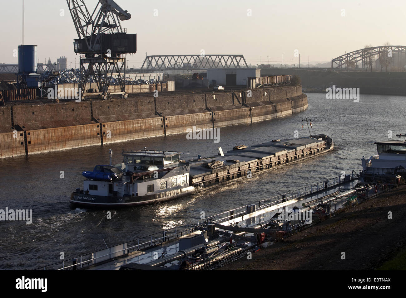 dockside crane of inner harbour and transport ship in canal, Germany, North Rhine-Westphalia, Ruhr Area, Duisburg Stock Photo