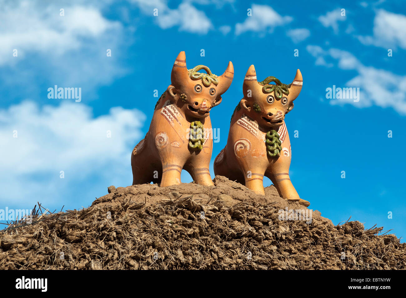Quechua ceramic bull statues on a roof for good luck, Peru, Atuncolla Stock Photo