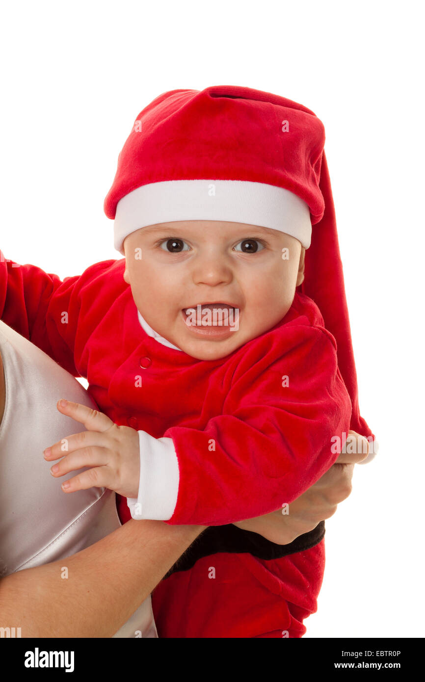 baby dressed as Santa Claus on the arms of its mother Stock Photo