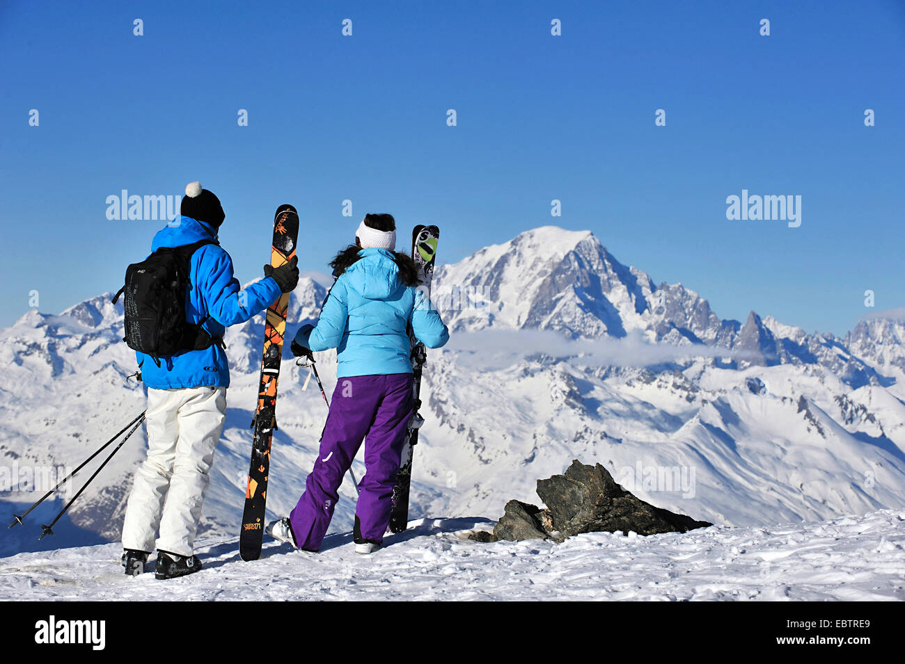 two skiers standing in the Alps and enjoying the view to Mont Blanc, France, Savoie, La Plagne Stock Photo