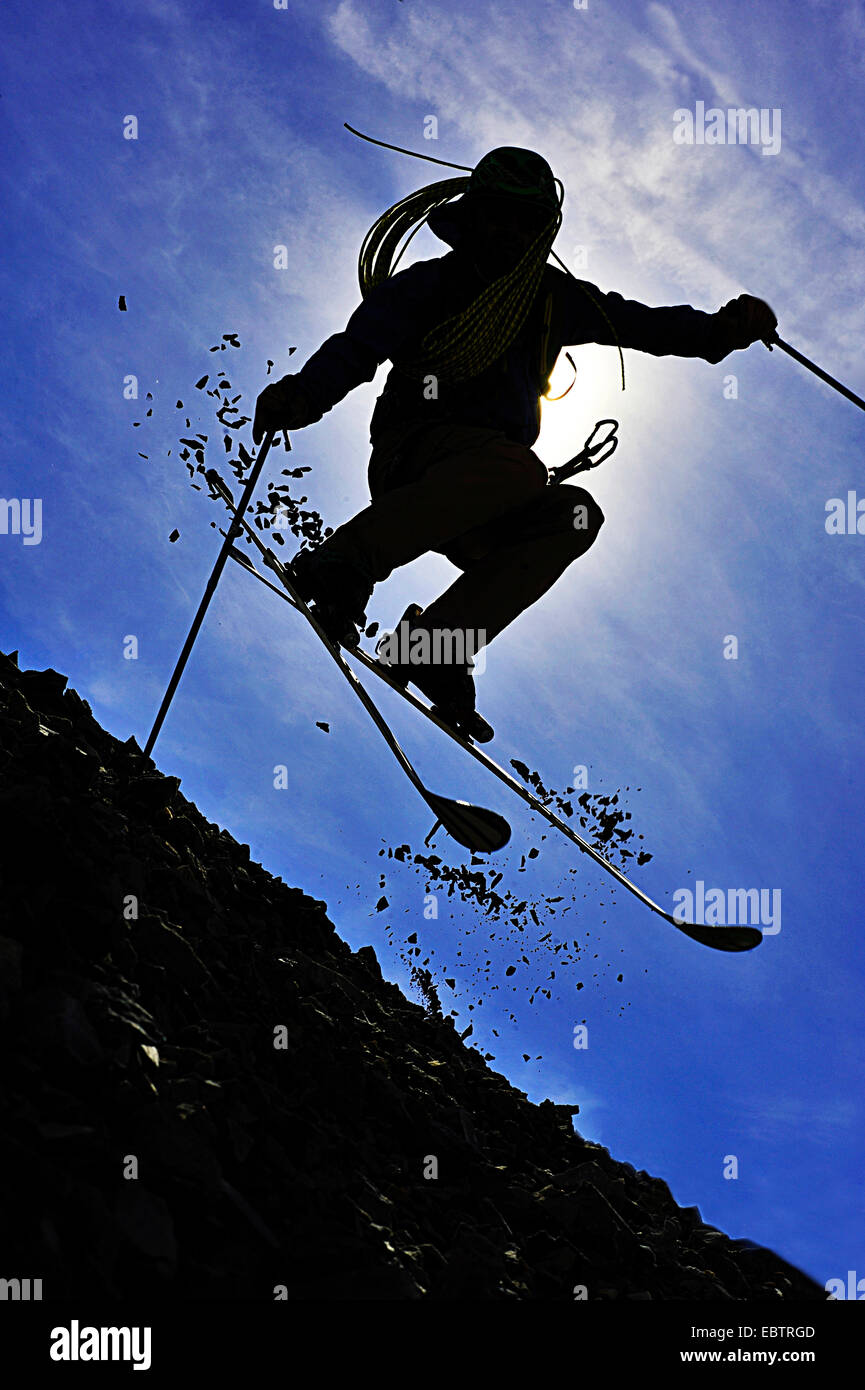 freeride skier disguised as oldfashioned adventurer going downhill on rocky slope Stock Photo