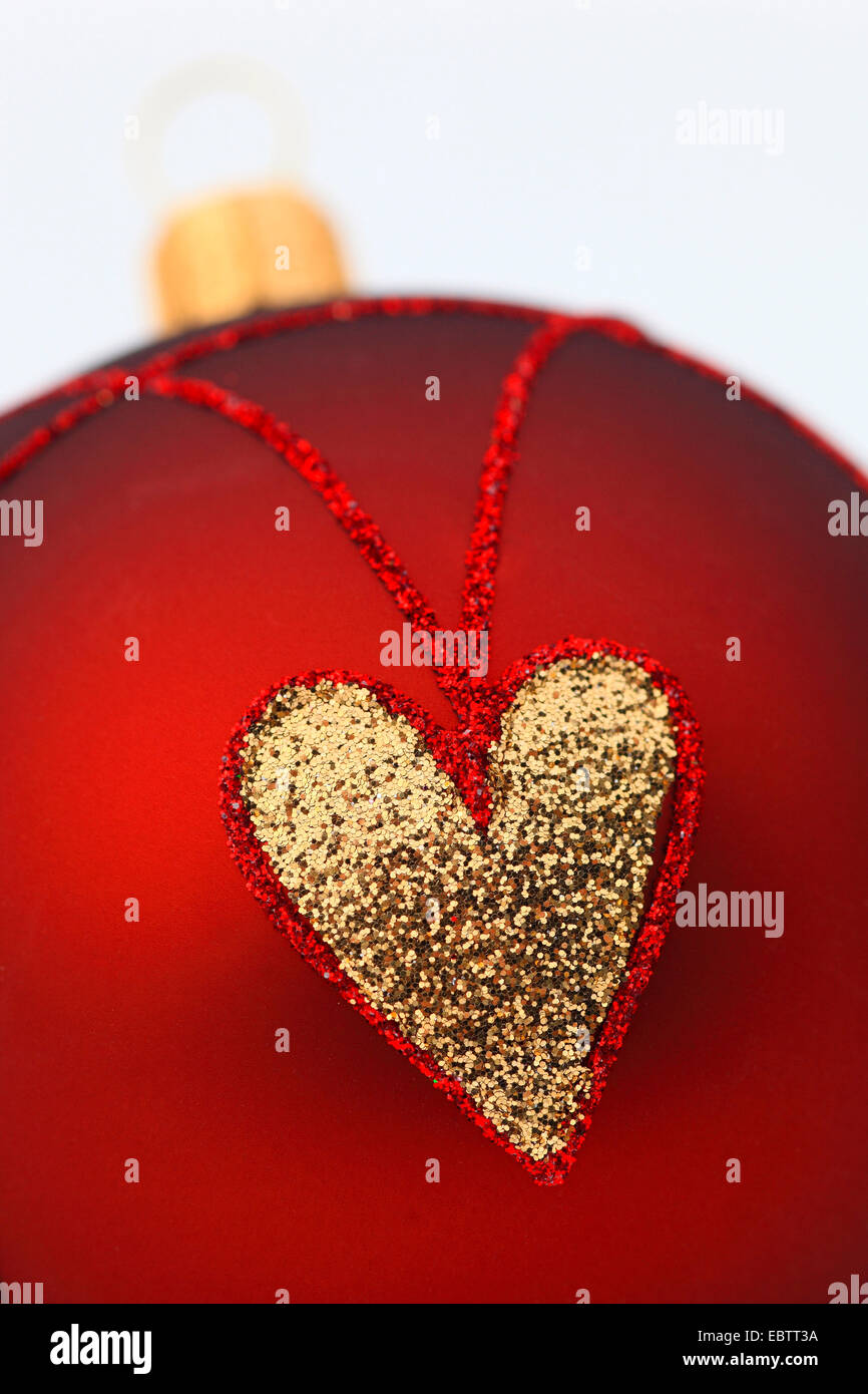 red christmas tree balls with golden hearts Stock Photo