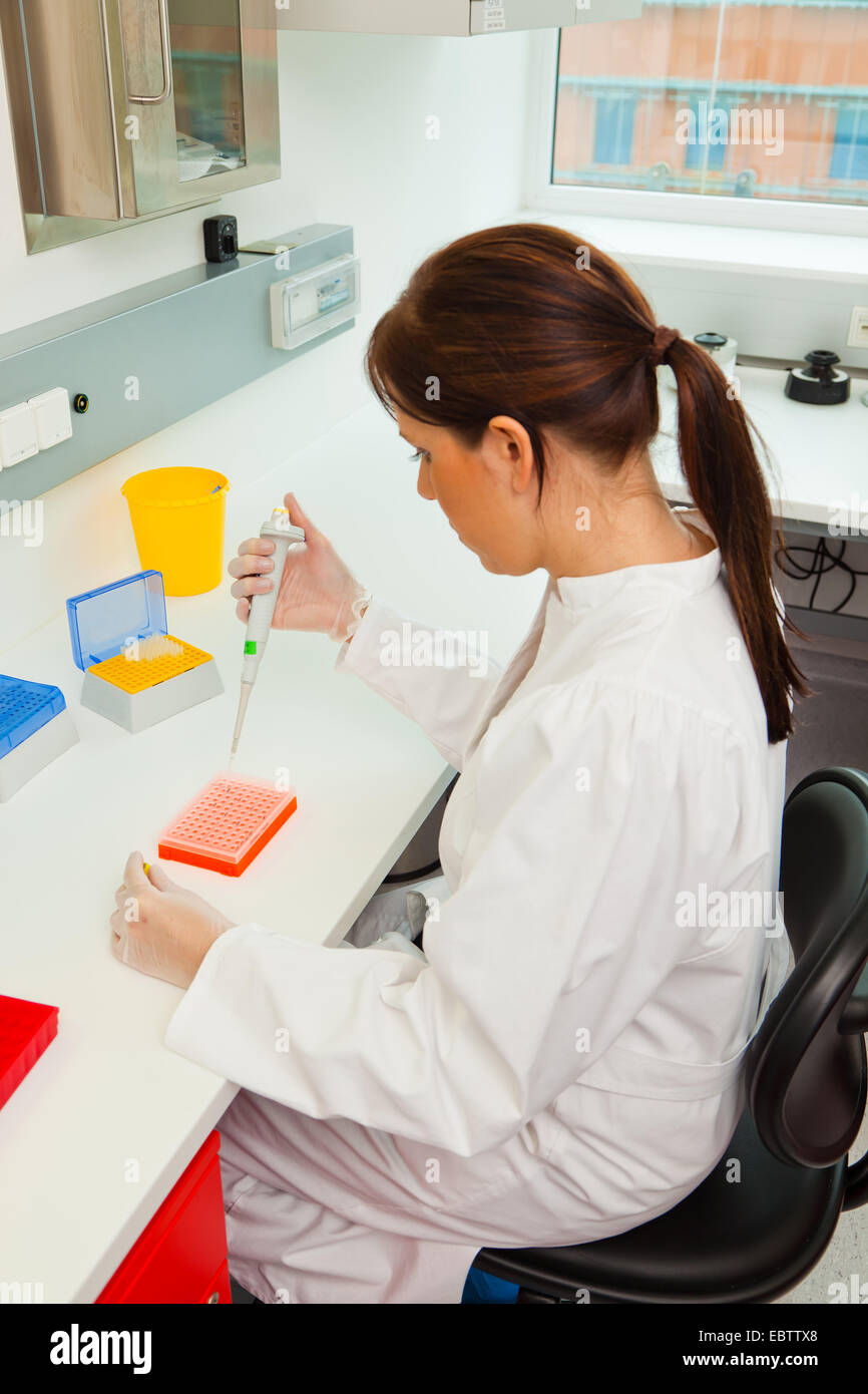 Woman in laboratory pipettes hi-res stock photography and images - Alamy