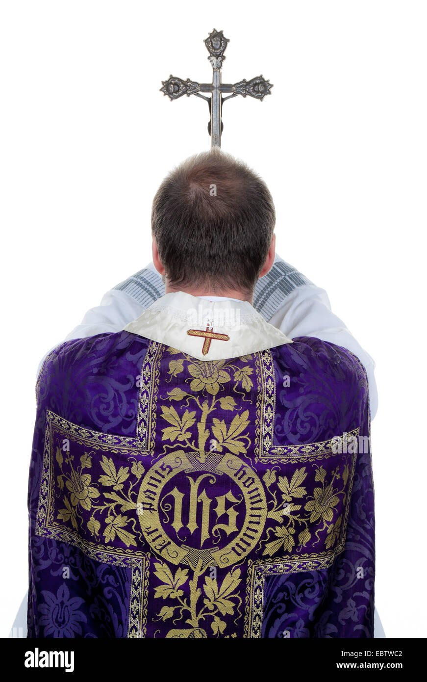 catholic priest ceremonially praying with a cross Stock Photo