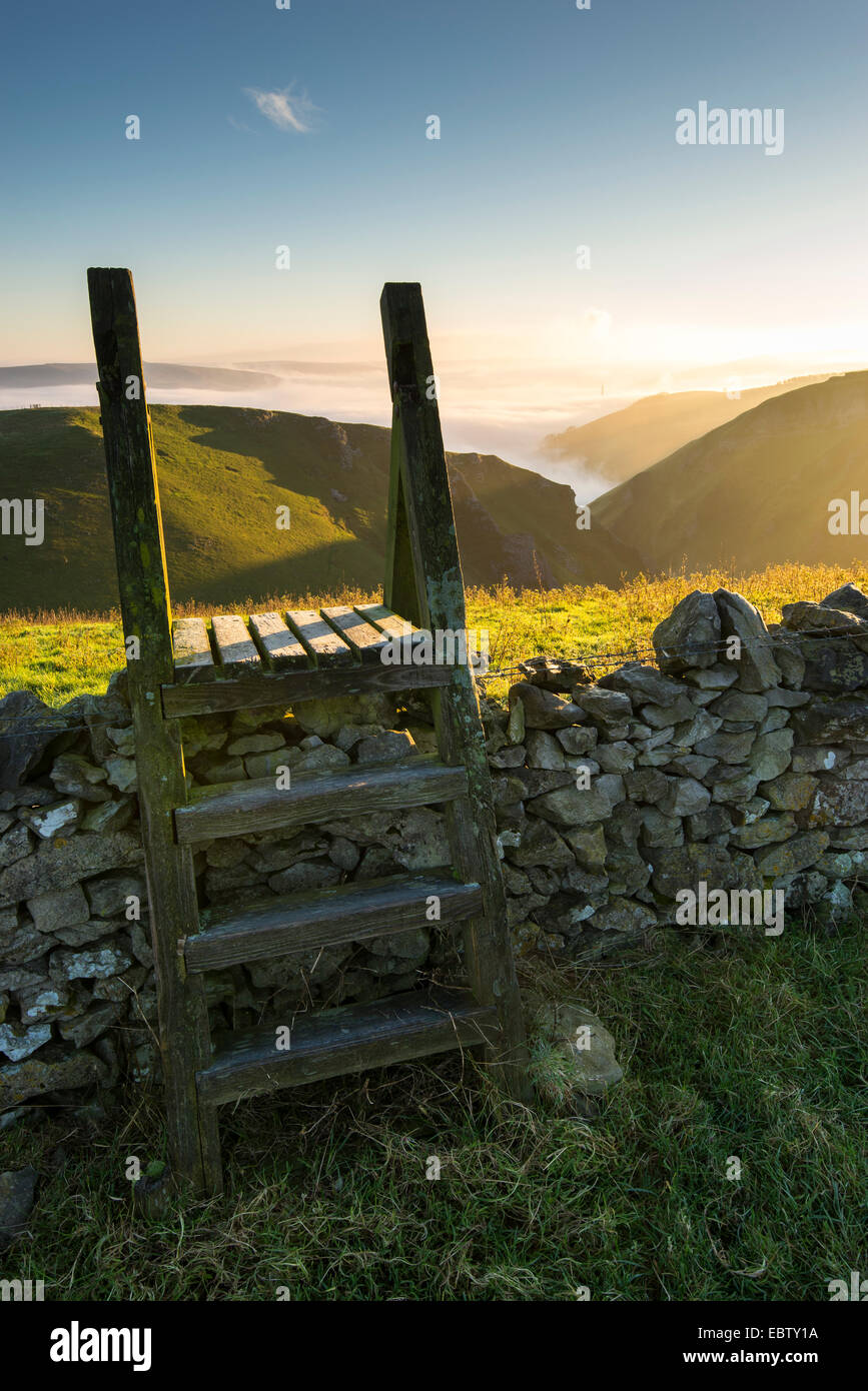 Wooden stile over a limestone wall above Winnats Pass in the Peak